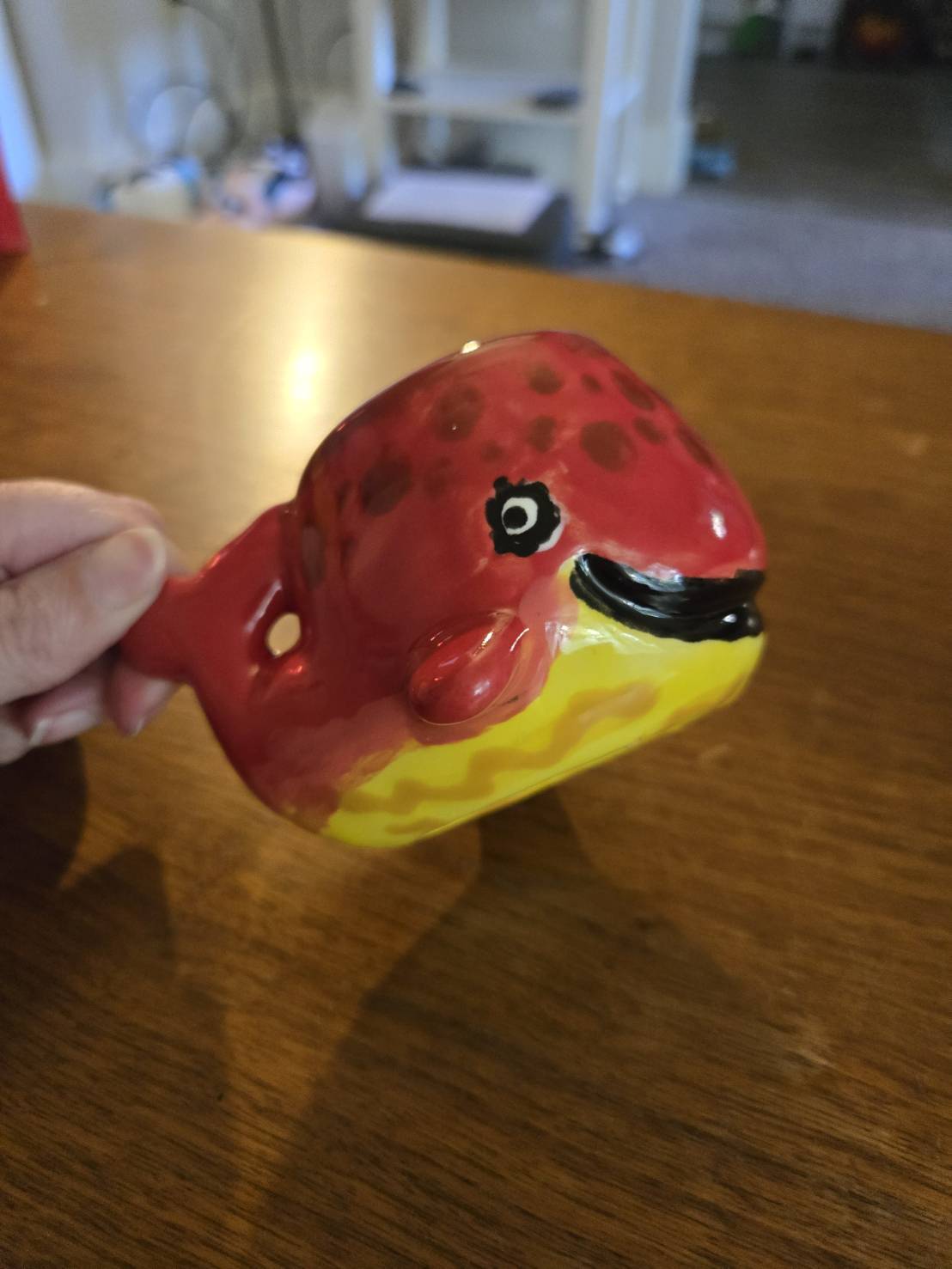 A Smiling red Painted Ceramic Whale