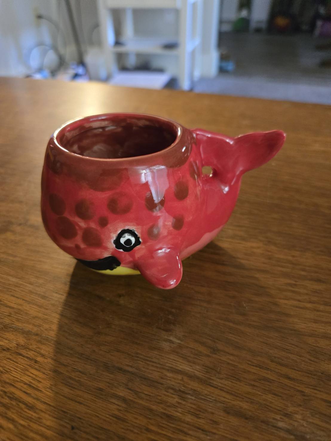 A Smiling red Painted Ceramic Whale